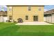 Spacious backyard featuring a lush green lawn and a concrete patio, ideal for barbecues and outdoor gatherings at 2657 Bullion Loop, Sanford, FL 32771