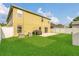 Large backyard boasts a manicured lawn and concrete patio, offering a great space for relaxation and activities at 2657 Bullion Loop, Sanford, FL 32771