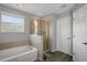 Bathroom featuring a white tub, glass shower and plank flooring at 2657 Bullion Loop, Sanford, FL 32771