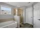 Bathroom featuring a white tub, glass shower and plank flooring at 2657 Bullion Loop, Sanford, FL 32771