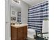 Bright bathroom featuring a sink, toilet, and shower with a blue-striped curtain at 2657 Bullion Loop, Sanford, FL 32771