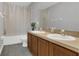 Bathroom featuring a double sink vanity, toilet, and shower with a clear curtain at 2657 Bullion Loop, Sanford, FL 32771