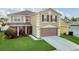 Inviting two-story home with a well-kept lawn, and a convenient two-car garage at 2657 Bullion Loop, Sanford, FL 32771