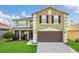 Charming two-story home featuring a two-car garage, a screened-in porch, and a well-maintained lawn at 2657 Bullion Loop, Sanford, FL 32771