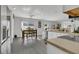 Bright kitchen with dining area features white cabinets, stainless steel appliances, and gray flooring at 2657 Bullion Loop, Sanford, FL 32771