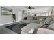 Inviting living room featuring a large sectional couch, dark rug, and open floor plan at 2657 Bullion Loop, Sanford, FL 32771