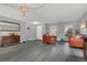 Bright living room with wood floors, comfortable seating, and a large mirror for a sense of openness at 2657 Bullion Loop, Sanford, FL 32771