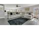 Open-concept living room with a large sectional couch, dark rug, and plenty of natural light at 2657 Bullion Loop, Sanford, FL 32771