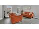 Bright living room featuring hardwood floors, modern decor, and comfortable leather seating at 2657 Bullion Loop, Sanford, FL 32771