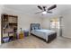 Cozy bedroom featuring a wood-look tiled floor, a ceiling fan, and natural light from the exterior window at 2809 Redditt Rd, Orlando, FL 32822