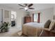 Bedroom featuring wood-look tiled flooring, natural light, and an ensuite bathroom with modern finishes at 2809 Redditt Rd, Orlando, FL 32822
