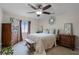 Traditional-style bedroom boasting ample space, light-wood tiled floors, and a bench at the foot of the bed at 2809 Redditt Rd, Orlando, FL 32822