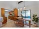 Dining area with a rustic wood table, modern pendant lighting, and tiled floors at 2809 Redditt Rd, Orlando, FL 32822