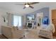 Cozy living room with vaulted ceilings, a ceiling fan, fireplace, and stylish nautical decor at 2809 Redditt Rd, Orlando, FL 32822