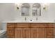 Modern bathroom features a double sink vanity, quartz countertop, and stylish arched mirrors with sconces at 2829 Lake Griffin Rd, Lady Lake, FL 32159