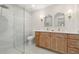 Luxurious bathroom featuring a glass shower, dual sinks, modern lighting, and high-end fixtures at 2829 Lake Griffin Rd, Lady Lake, FL 32159