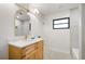 Updated bathroom with wood vanity, gold mirror, and modern fixtures at 2829 Lake Griffin Rd, Lady Lake, FL 32159