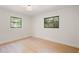 Bedroom featuring wood-look flooring and two windows at 2829 Lake Griffin Rd, Lady Lake, FL 32159