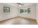 Bright bedroom with large windows providing natural light and wood-look floors at 2829 Lake Griffin Rd, Lady Lake, FL 32159