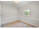 Cozy bedroom with modern wood floors and a window that brings in natural lighting at 2829 Lake Griffin Rd, Lady Lake, FL 32159
