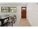 Bright dining room featuring paneled walls, and a stylish table set beneath a modern window at 2829 Lake Griffin Rd, Lady Lake, FL 32159