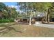 Charming single-story home featuring a brick facade, large windows, and mature trees on a spacious lot at 2829 Lake Griffin Rd, Lady Lake, FL 32159