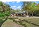 Exterior view of a single-story brick house with a well-manicured lawn at 2829 Lake Griffin Rd, Lady Lake, FL 32159