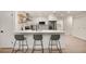 Contemporary kitchen featuring white cabinetry, stainless steel appliances, and a convenient breakfast bar at 2829 Lake Griffin Rd, Lady Lake, FL 32159