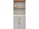 Close up of the white kitchen cabinets and countertop, with a wooden open shelf above at 2829 Lake Griffin Rd, Lady Lake, FL 32159