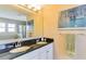 Bathroom featuring a double sink vanity with black granite countertop and decorative art on the walls at 312 Partridge Pea Ln, Ocoee, FL 34761