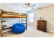 Charming bedroom features a wooden bunk bed, large beanbag, and dresser with light streaming through a window at 312 Partridge Pea Ln, Ocoee, FL 34761