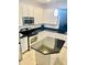 Modern kitchen features white cabinetry, stainless steel appliances, and dark countertop island for prep at 312 Partridge Pea Ln, Ocoee, FL 34761