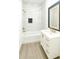 Modern bathroom with marble-look tile, gold-tone fixtures, and a white vanity at 313 Bass Ct, Kissimmee, FL 34759
