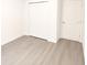 Bright bedroom features light gray wood flooring and a closet with bi-fold doors at 313 Bass Ct, Kissimmee, FL 34759