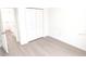 Bright bedroom features light gray wood flooring and a closet with bi-fold doors at 313 Bass Ct, Kissimmee, FL 34759