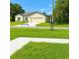 Charming home with a well-manicured lawn and a neutral-colored exterior at 313 Bass Ct, Kissimmee, FL 34759