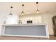 Kitchen island with white countertop and pendant lighting at 313 Bass Ct, Kissimmee, FL 34759