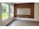 Bright living room with wood slat feature wall and natural light streaming through large windows at 313 Bass Ct, Kissimmee, FL 34759