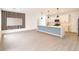 Modern open-concept living room and kitchen with stylish wood accent wall and island pendant lighting at 313 Bass Ct, Kissimmee, FL 34759