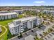 Overhead view of modern apartments with lush landscaping, parking, and a view of the surrounding community at 3180 Paradox Cir # 304, Kissimmee, FL 34746