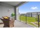 Balcony with wicker chairs offering a view of the green lawn and community buildings at 3180 Paradox Cir # 304, Kissimmee, FL 34746