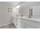Bright bathroom with double sinks, white countertops, and large mirror reflecting a neutral color scheme at 3180 Paradox Cir # 304, Kissimmee, FL 34746