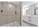 Modern bathroom featuring a tiled walk-in shower with glass door and a double sink vanity at 3180 Paradox Cir # 304, Kissimmee, FL 34746