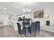 Dining area connected to the kitchen featuring seating for six and elegant lighting at 3180 Paradox Cir # 304, Kissimmee, FL 34746