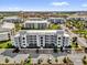 Overhead view of a modern apartment building with ample parking, beautiful landscaping, and a welcoming entryway at 3180 Paradox Cir # 304, Kissimmee, FL 34746