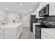 Bright kitchen features stainless steel appliances, white cabinetry, and a center island at 3180 Paradox Cir # 304, Kissimmee, FL 34746