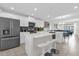 Modern kitchen with white cabinetry, black appliances, a center island with bar stools, and an open layout at 3180 Paradox Cir # 304, Kissimmee, FL 34746