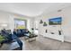 Comfortable living room with modern decor, a mounted TV, and access to a balcony at 3180 Paradox Cir # 304, Kissimmee, FL 34746