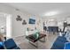 Open-concept living room and dining area with a TV, modern decor and comfortable seating at 3180 Paradox Cir # 304, Kissimmee, FL 34746