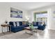 Cozy living room features two blue sofas, a coffee table, and a view to the balcony at 3180 Paradox Cir # 304, Kissimmee, FL 34746